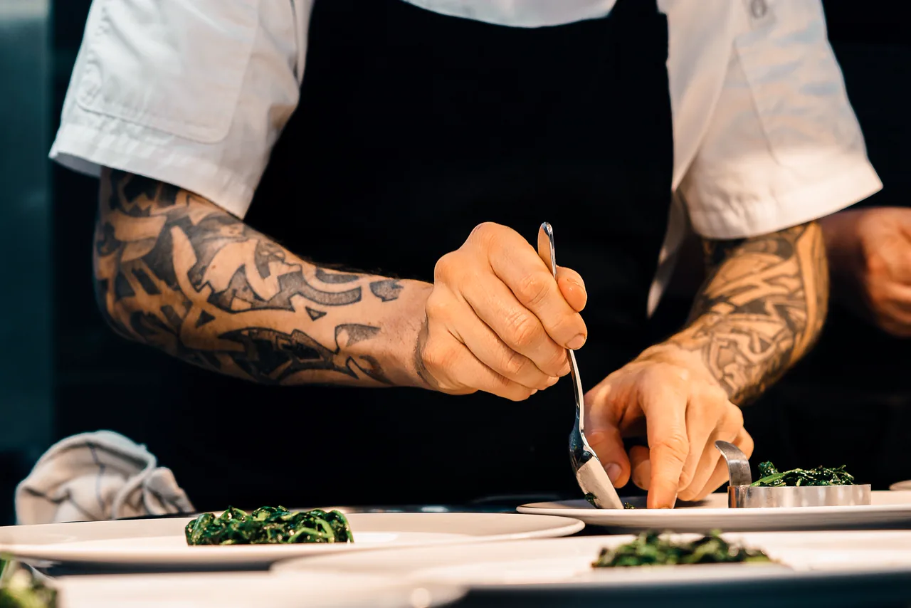 A chef plating dishes in a private kitchen