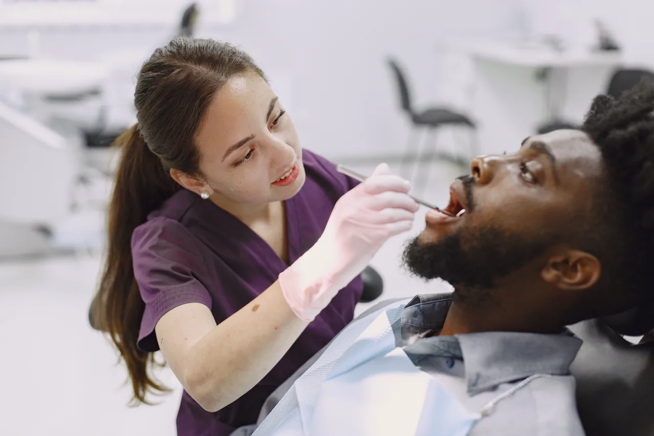 A dentist with a patient in a bright practice